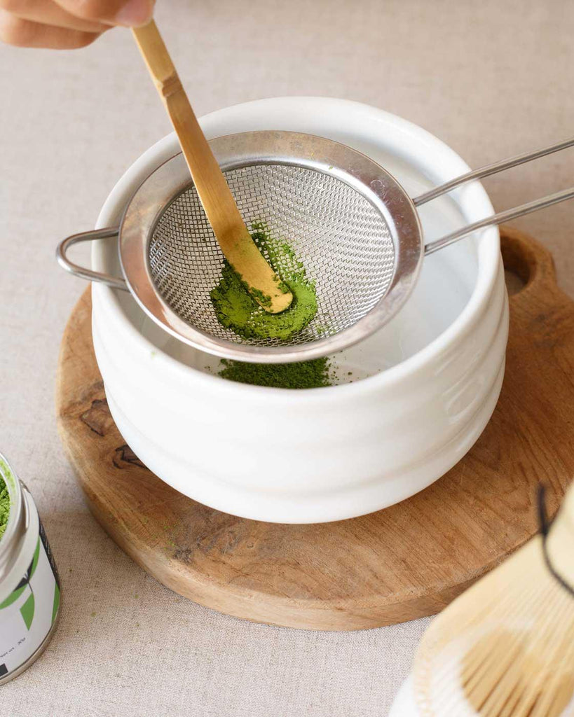 Use your Chashaku Bamboo Scoop to swift matcha powder in the Chawan tea cup