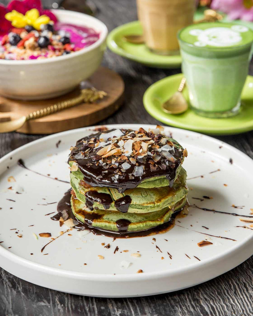 Delicious matcha pancakes with vegan nutella, caramelised banana and coconut flakes